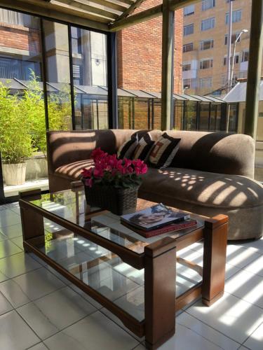 a living room with a couch and a glass table at Hotel NASS Pinar del Lago in Cuenca