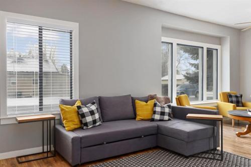 a living room with a gray couch and yellow pillows at #StayInMyDistrict Historic Charm in Twin Falls