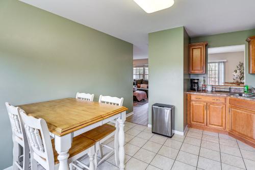 a kitchen and dining room with a wooden table and chairs at Family Getaway 16 Mi to Pittsburgh! in Monroeville