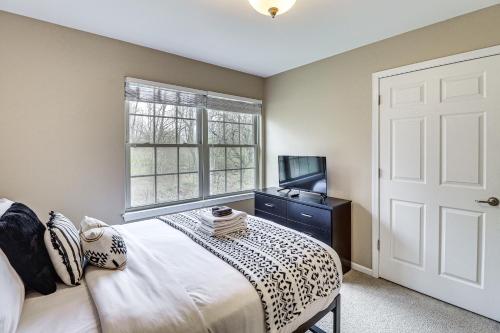 a bedroom with a bed and a tv and a window at Family Getaway 16 Mi to Pittsburgh! in Monroeville