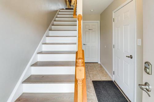 a staircase in a home with a wooden hand rail at Family Getaway 16 Mi to Pittsburgh! in Monroeville