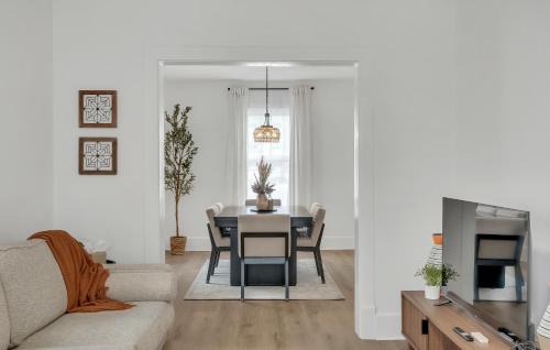 a living room with a table and a couch at Charming Retreat - Close to Zoo and Downtown in Omaha