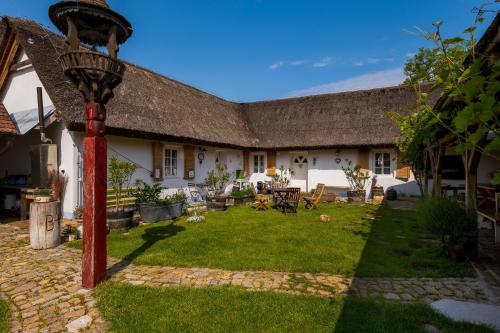 a courtyard of a house with a grass yard at Penzion Pastuška in Brod nad Dyjí