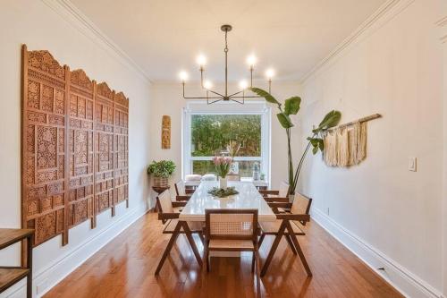 a dining room with a table and chairs and a window at Exquisite Luxury Estate - Steps to Downtown in Toronto