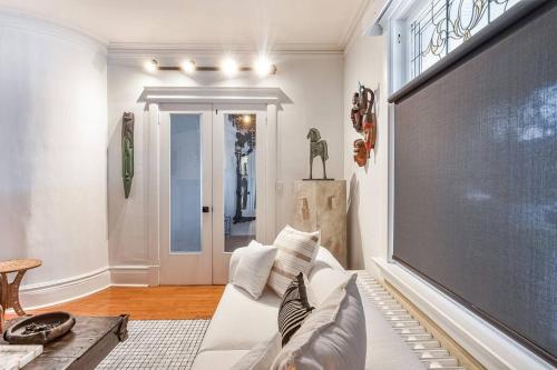 a living room with a white couch and a large screen at Exquisite Luxury Estate - Steps to Downtown in Toronto