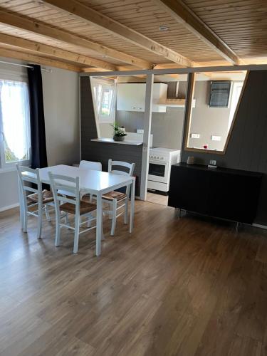 a kitchen and dining room with a table and chairs at Chalet Charmant Monika avec Piscine in Yvoir