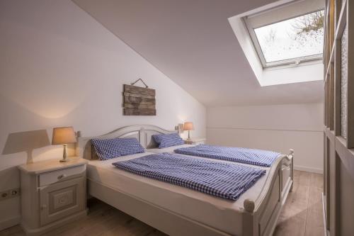 オーバーアウドルフにあるBergschlössl - Massionettwohnung 13の白いベッドルーム(ベッド1台、窓付)