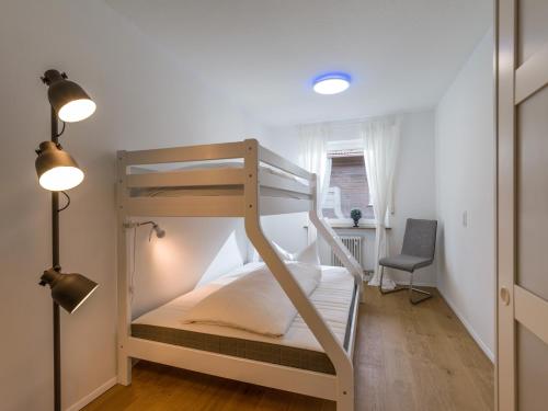 a bunk bed in a room with a desk and a chair at Moderne Bergstube mit 2 Schlafzimmer und großen Balkon in Oberaudorf