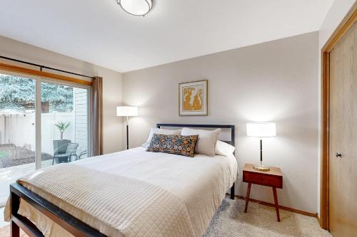 a bedroom with a large bed and a window at Warm & Inviting in Boise
