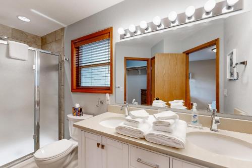 a bathroom with a sink and a toilet and a mirror at Warm & Inviting in Boise