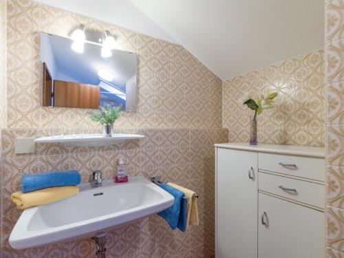 a bathroom with a sink and a mirror at Ferienwohnanlage Oberaudorf F8 mit Hallenbad und Sauna in Oberaudorf