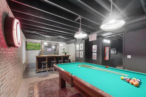a billiard room with a pool table and a bar at Coopers North in Old Town - Hot Tub & Pool Table! in Fort Collins