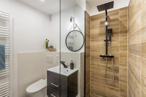 ein Badezimmer mit einem WC, einem Waschbecken und einem Spiegel in der Unterkunft Rosel s Mountain Lodge in Oberaudorf