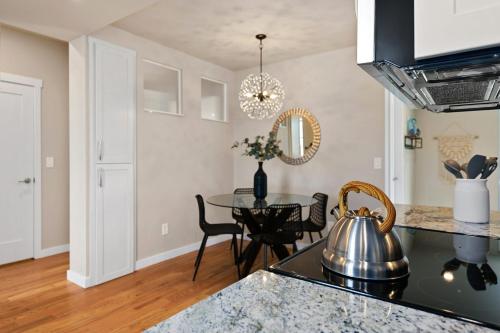 a kitchen with a table with a tea kettle at Bright and Stylish Home - Great Central Location! in Timnath