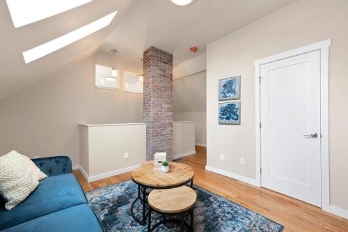 a living room with a blue couch and a table at Bright and Stylish Home - Great Central Location! in Timnath