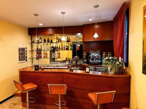 a bar in a restaurant with two chairs and a counter at Ben Hur Rimini in Rimini