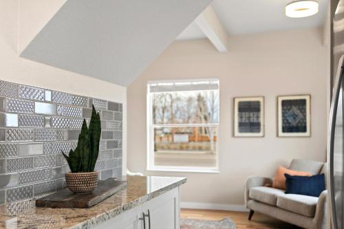a living room with a couch and a window at Bright and Stylish Home - Great Central Location! in Timnath