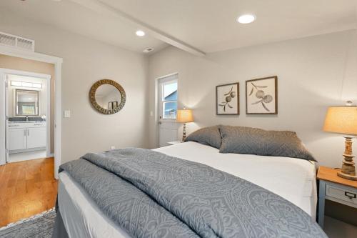 a bedroom with a bed and a mirror at Bright and Stylish Home - Great Central Location! in Timnath