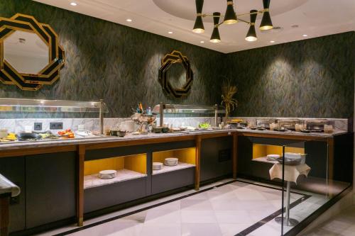 a bathroom with a counter with sinks and a mirror at DoubleTree by Hilton Madrid-Prado in Madrid