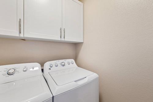 a white washer and dryer in a laundry room at Bright and Stylish Home - Great Central Location! in Timnath