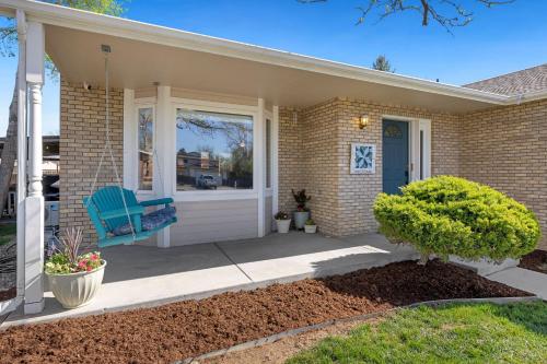 a house with a blue chair on a porch at Charming Home with RV Parking - 30 miles from RMNP! in Loveland