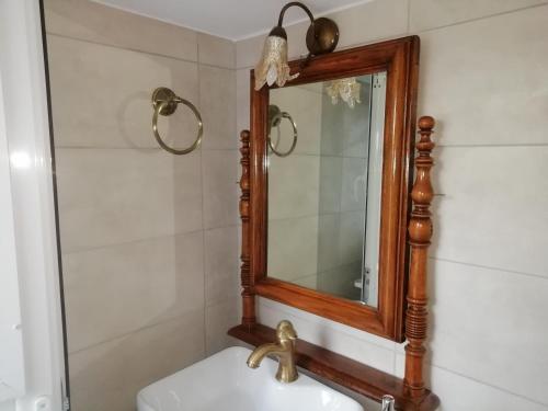 a bathroom with a mirror and a sink at Aloni Farmhouse in Karistos