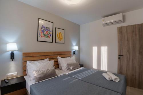 a bedroom with a bed with two towels on it at Anassa Villas in Keratokampos