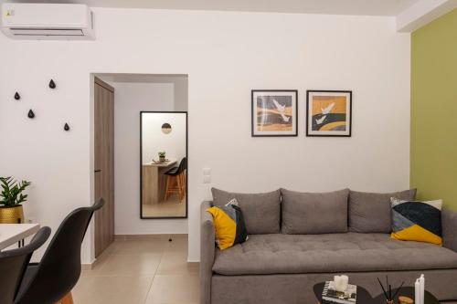 a living room with a couch and a table at Anassa Villas in Keratokampos