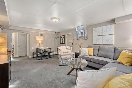 a living room with a couch and a table at Garden Level Apt Mtn Ave - 8 min walk to Old Town! in Fort Collins