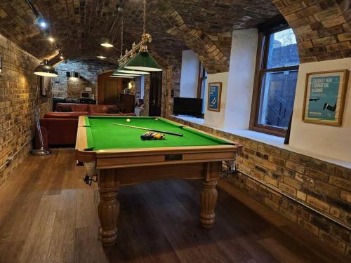 a room with a pool table in a room at The Armoury: Stylish WW1 Bunker in North Queensferry