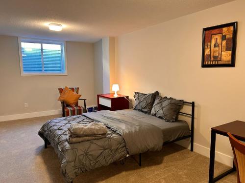 a bedroom with a bed and a table and a window at Moral’s Inn- Ottawa in Ottawa