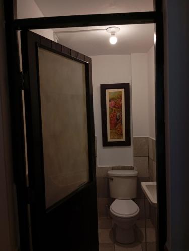 a bathroom with a toilet and a sink at Goya'sHostel in Camaná