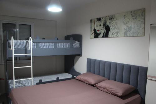 1 dormitorio con litera y 1 litera con escalera en Sirel Home en Durrës