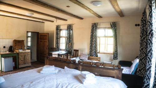 a bedroom with a large bed and two windows at Michelsberger Haus in Cisnadioara