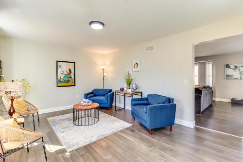 a living room with two blue chairs and a table at Hot Tub and Fire Pit Family Home in Tobyhanna in Tobyhanna