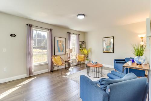 a living room with a blue couch and chairs at Hot Tub and Fire Pit Family Home in Tobyhanna in Tobyhanna