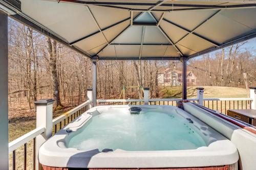 a hot tub on the deck of a house at Hot Tub and Fire Pit Family Home in Tobyhanna in Tobyhanna