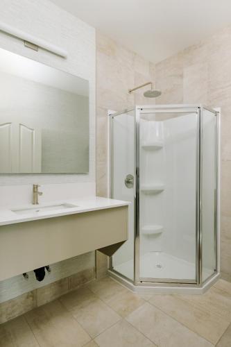 a bathroom with a sink and a shower at Balcomo, a Ramada by Wyndham in Penticton