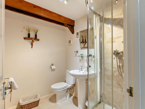 a bathroom with a toilet and a glass shower at 4 bed in Okehampton 49511 in Sampford Courtenay