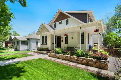a white house with a yard at Old Town Oasis - Spacious Artisan Home in Old Town in Fort Collins