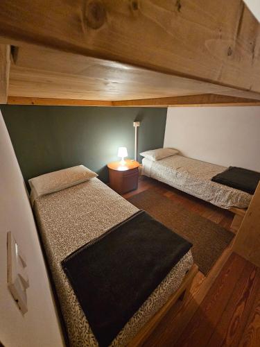 an overhead view of a bedroom with two bunk beds at Rifugio Guglielmo e Giovanni Pelizzo in Montemaggiore