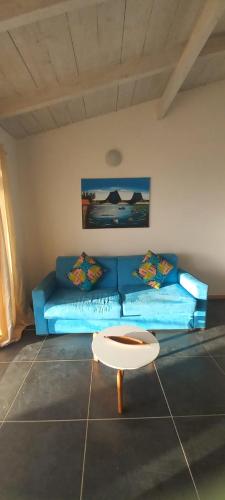 a living room with a blue couch and a coffee table at Sal Rei apartaments, Boa Vista, free WI-FI in Sal Rei