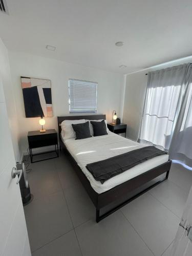 a bedroom with a large bed and two night stands at Stylish Pool Home in Hollywood