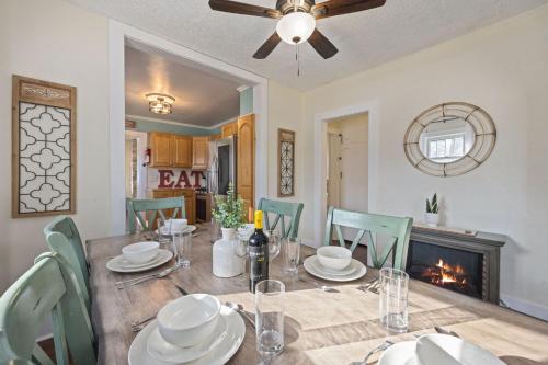 a dining room with a table and chairs and a fireplace at Newly Renovated in the Heart of Historic Loveland in Loveland