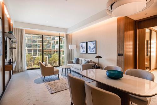 a living room with a dining table and a couch at Luxury 1BR The Address Opera, Downtown Dubai in Dubai