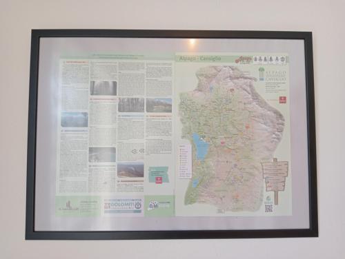 a framed map hanging on a wall at Appartamento 'Io e te' in Pieve dʼAlpago