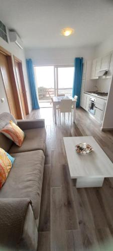 a living room with a couch and a table at Sal Rei apartaments, Boa Vista, free WI-FI in Sal Rei