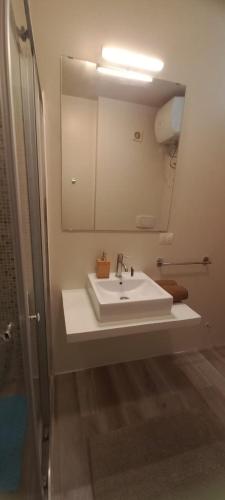 a bathroom with a white sink and a mirror at Sal Rei apartaments, Boa Vista, free WI-FI in Sal Rei
