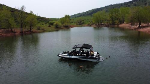 a group of people in a boat on a river at The Horsetooth Stoop - Biking, Boating & Sunsets in Fort Collins