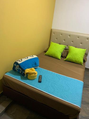 a bedroom with two beds with green pillows at Hotel Oiba Alfa Plaza in Oiba